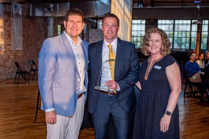 Johnson & Johnson honoree holding an award at the spring benefit
